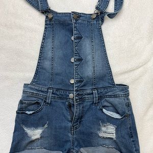 women's denim overall with rips on the front